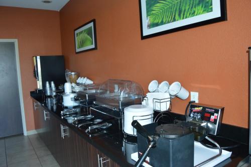 a kitchen with a counter with many dishes on it at Sleep Inn & Suites Elk City in Elk City