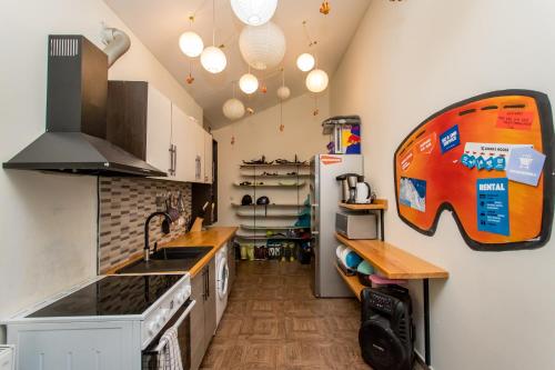 a kitchen with a sink and a stove at Riders House New Gudauri in Gudauri