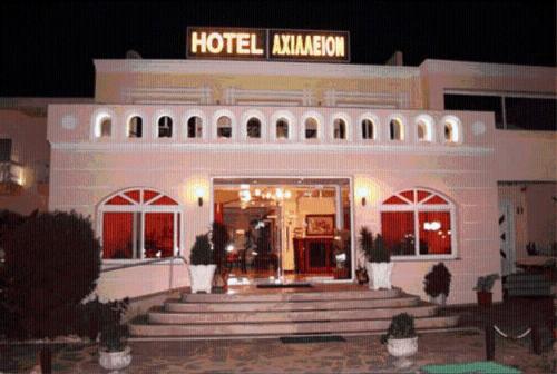 a hotel with stairs in front of a building at Achillion Palace in Kalambaki