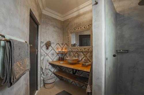 a bathroom with a sink and a mirror at YEBO Boutique Guesthouse in Somerset West
