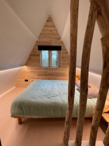 a bedroom with a bed in a attic at Sunclass Durbuy huisje 205 in Durbuy