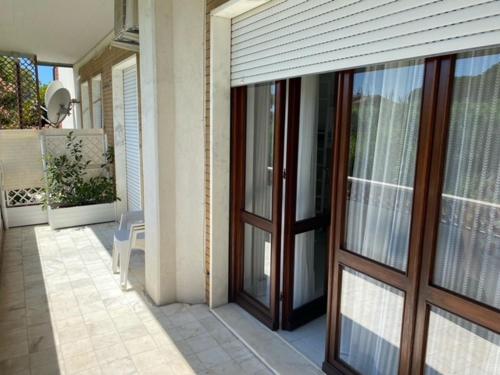 a house with sliding glass doors on a patio at B&B Tra Mare e Marmo in Marina di Carrara