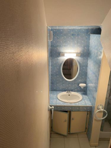 a bathroom with a sink and a mirror at Chalet "Le Mayouret" - STUDIO N°4 - chemin des écureuils in Cauterets
