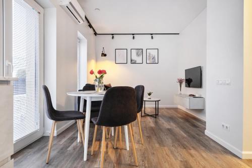 a dining room with a table and chairs at Owls Hill Apartment in Kaunas