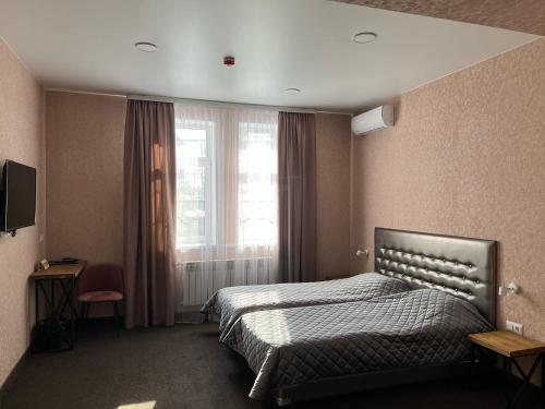 a hotel room with a bed and a window at отель "ПАРК-Л" in Lipetsk