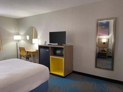 a hotel room with a bed and a television at Days Inn by Wyndham Colby in Colby