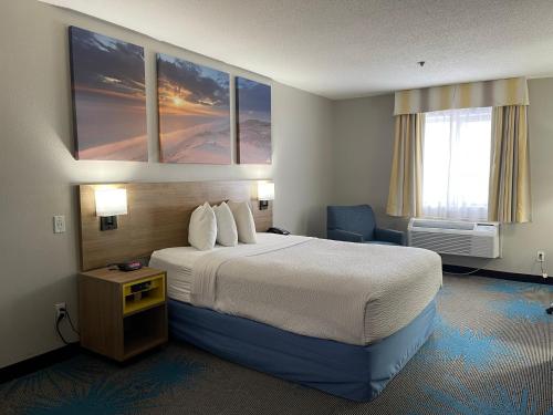 a hotel room with a large bed and a window at Days Inn by Wyndham Colby in Colby