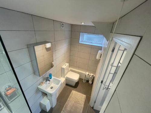 a small bathroom with a sink and a toilet at Welcome properties - Self Check-In whole apartment in Swindon