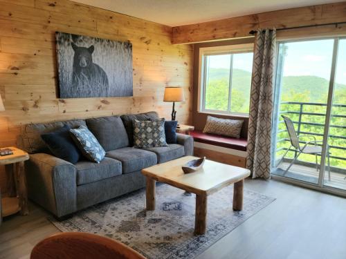 a living room with a couch and a table at Mountain Villa Magnificent Views - 2 Pools, Fireplace & Hot Tub in Gatlinburg