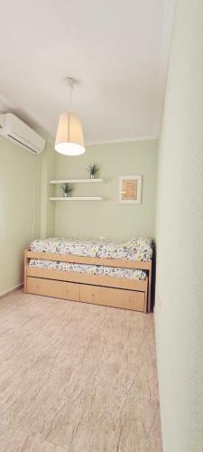 a bedroom with a bed in the corner of a room at APARTAMENTO EN PUNTA UMBRÍA in Punta Umbría