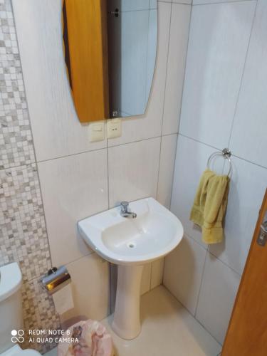 y baño con lavabo y espejo. en Apart cómodo y seguro a pasos de todo 33, en Ciudad del Este