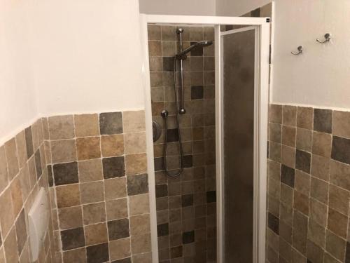 a bathroom with a shower with a glass door at La casina in Acquaviva