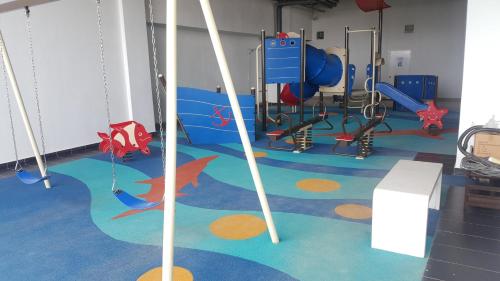 a gym with a play room with a playground at Prestige Sky Riverfront in Kota Bharu