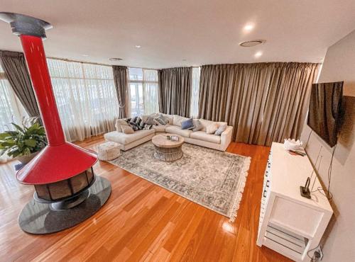 a living room with a large red object in the middle at Jewel of Brooklyn - Hawkesbury River Marina in Brooklyn