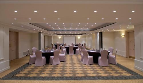 a meeting room with tables and chairs in a room at Radisson Blu Martinez Beirut in Beirut