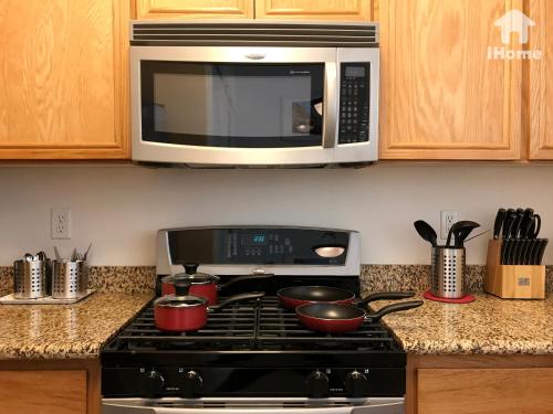a kitchen with a stove with a microwave above it at Perfect Apt near UCLA w Parking Gym Pool WIFI in Westwood B3 in Los Angeles