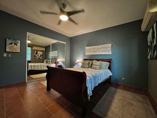 a bedroom with a bed and a ceiling fan at Pancho's Paradise - Rainforest Guesthouse with Pool, Gazebo and View in Canovanas