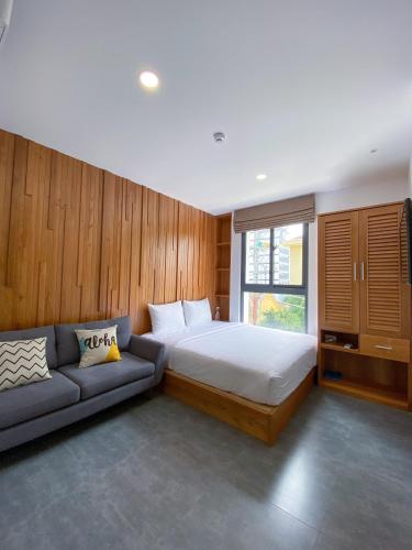 a bedroom with a bed and a couch at Coast House Boutique Hotel in Nha Trang