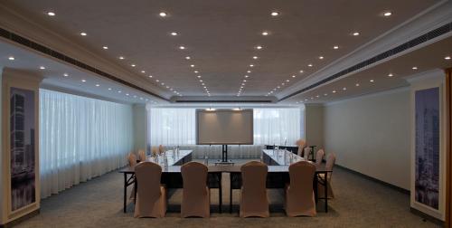 a conference room with a table and chairs and a large screen at Radisson Blu Martinez Beirut in Beirut