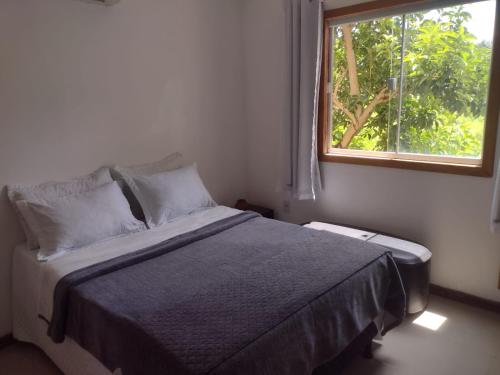 Ένα ή περισσότερα κρεβάτια σε δωμάτιο στο Casa Jequitibá Quartos Mobiliados
