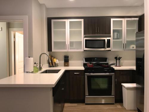 a kitchen with a stove and a microwave at Perfect Apt near UCLA w Parking Gym Pool WIFI in Westwood B3 in Los Angeles