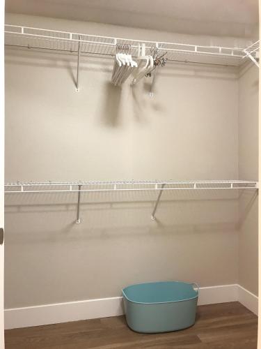 a closet with a blue bucket on a shelf at Perfect Apt near UCLA w Parking Gym Pool WIFI in Westwood B3 in Los Angeles