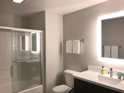 a bathroom with a toilet and a sink and a shower at Perfect Apt near UCLA w Parking Gym Pool WIFI in Westwood B3 in Los Angeles