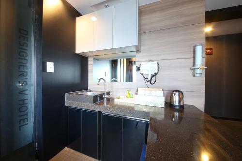 a kitchen with a sink and a counter top at Moonbay Hotel in Busan