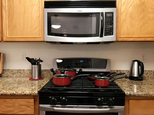 a kitchen with a stove top with a microwave at Perfect Apt near UCLA w Parking Gym Pool WIFI in Westwood B3 in Los Angeles