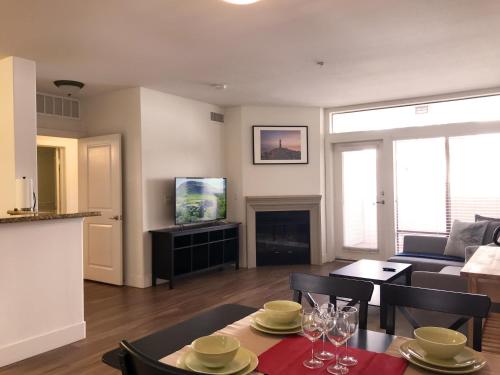 a living room with a couch and a table with chairs at Perfect Apt near UCLA w Parking Gym Pool WIFI in Westwood B3 in Los Angeles