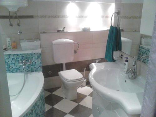 a bathroom with a toilet and a sink at Room Sarah in Rijeka