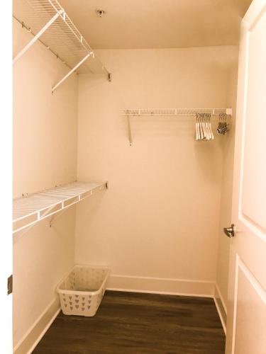 a walk in closet with shelves and a basket at Perfect Apt near UCLA w Parking Gym Pool WIFI in Westwood B3 in Los Angeles