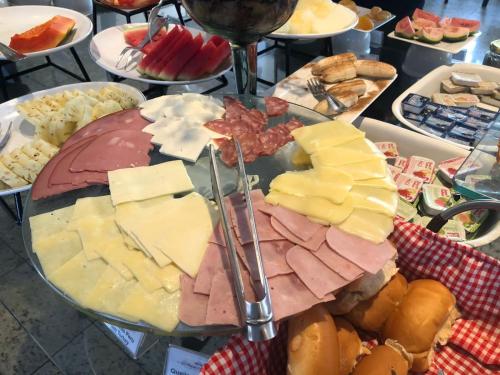 a tray of different types of cheese and other appetizers at Gran Lençóis Flat Barreirinhas APT 510 in Barreirinhas