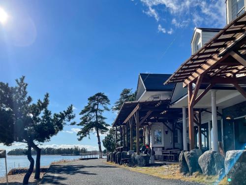 a building next to a body of water at Biwa-Lakeside Cottage B B Dylan in Minami-komatsu