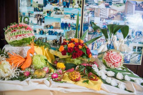 a display of vegetables and flowers on a table at Smartline Meridian Hotel in Sunny Beach