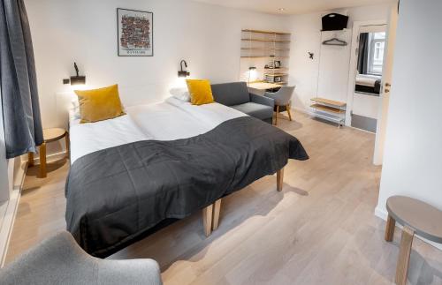 a bedroom with a large bed and a living room at Go Hotel Ansgar in Copenhagen