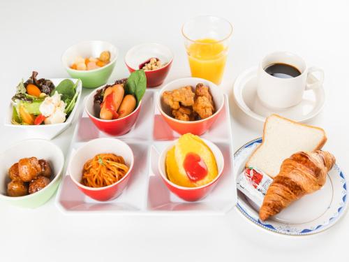 a tray of food with different bowls of food at Sotetsu Fresa Inn Daimon in Tokyo