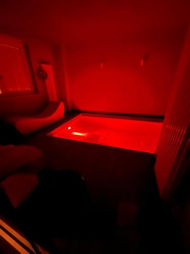 a room with a red light in the dark at Hotel Bella Napoli ristorante & spa in Foggia