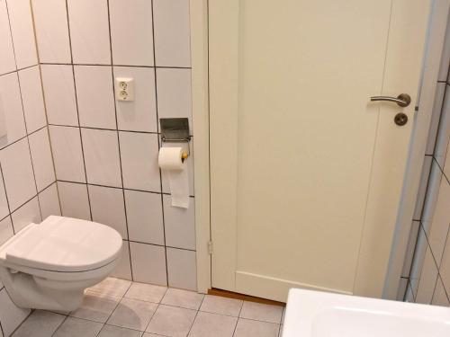 a bathroom with a toilet and a roll of toilet paper at 10 person holiday home in Brattvåg in Brattvåg