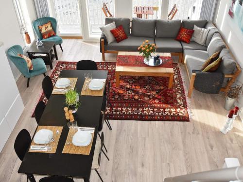 a living room with a couch and a table at 10 person holiday home in Brattvåg in Brattvåg