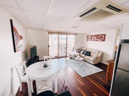 a living room with a table and a couch at Riverfront Dream on the Hawkesbury - Water View in Brooklyn