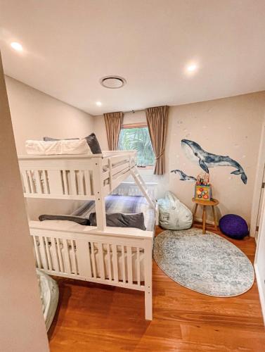 a bedroom with two bunk beds in a room at Luxe at Brooklyn - Hawkesbury River Marina in Brooklyn