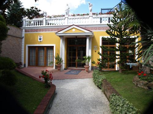 a yellow house with a walkway in front of it at Villa-Angelina in Langenzersdorf
