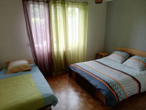Säng eller sängar i ett rum på Appartement dans Villa