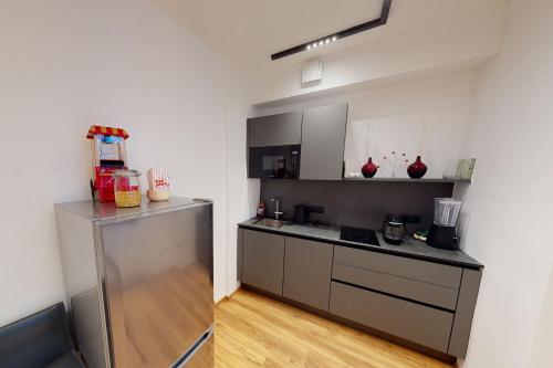 a kitchen with a stainless steel refrigerator in a room at Hofgasse Apartments in Innsbruck