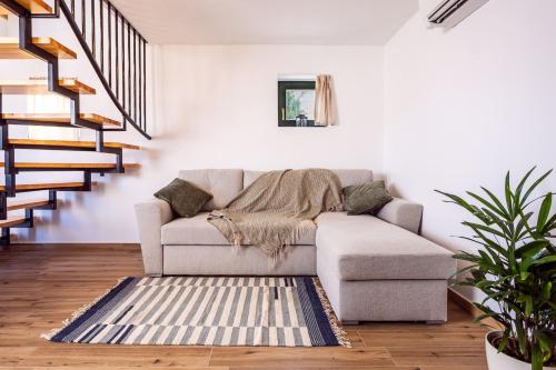 a living room with a couch and a rug at Barbár Borbár in Szekszárd