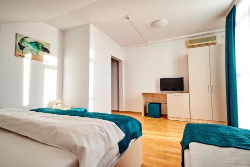 Postel nebo postele na pokoji v ubytování Hotel-Apartments Roxy&Maryo