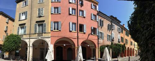 a large brick building with arches in a street at Il Fonticolo Room & Breakfast in Modena