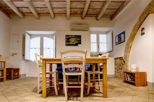 a kitchen with a wooden table and chairs at Casa Clio in Syracuse