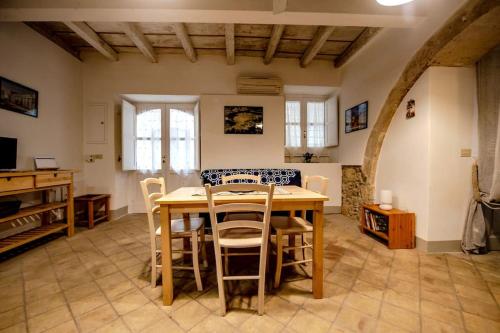a dining room with a wooden table and chairs at Casa Clio in Syracuse